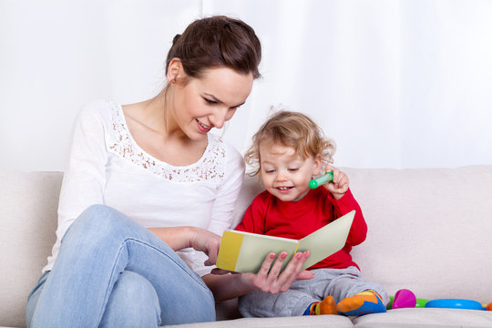 Mother reading book with child