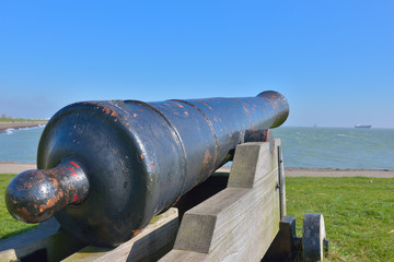 Old cannon on entrance to Slijk harbor