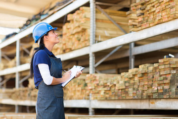 female worker stock taking in warehouse