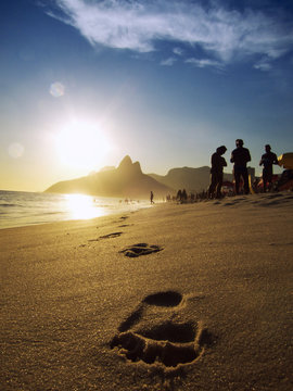 Footprints on the Shore of Ipanema Beach at Sunset