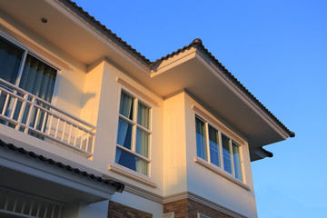 Fototapeta na wymiar Big house modern style with sunshine and blue sky background