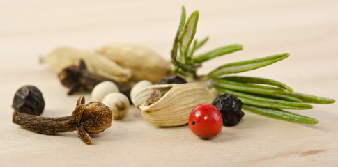 fragrant scented natural spices with a sprig of rosemary on the