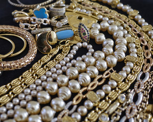 pirate's gold, variety of precious jewelry closeup, strong bokeh