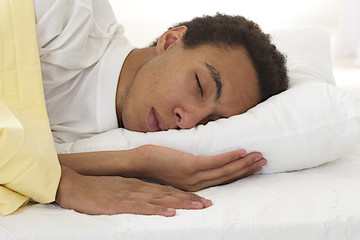 Fototapeta na wymiar African american male sleeping in his bed.