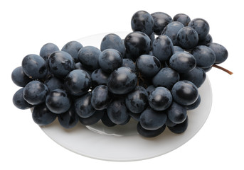 Black grapes on the plate