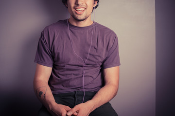 Happy young man listening to music