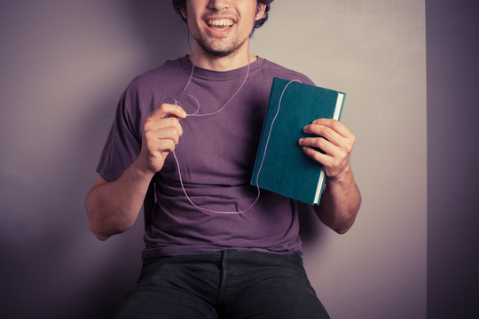 Young man listening to audio book
