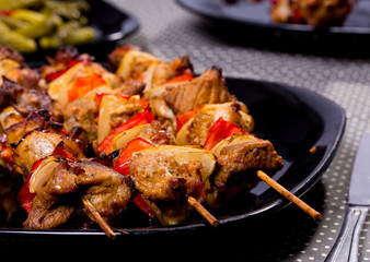 Grilled shashlik on the black plate,