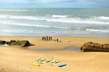 Fototapeta na wymiar Group of surfers on the beach, learning, Cadiz, Spain