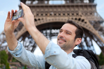 Young attractive tourist taking selfie in Paris
