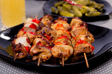 Grilled shashlik on the black plate,