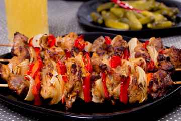 Grilled shashlik on the black plate,