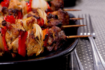 Grilled shashlik on the black plate,