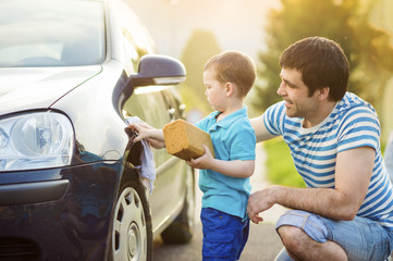 Father and son washing car