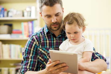 Father and daughter with tablet