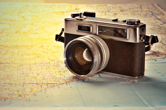 Old photo camera on world map