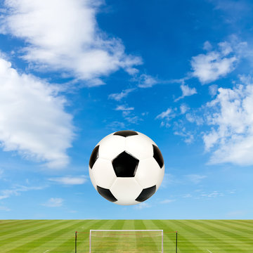 soccer ball with soccer field against  blue sky background
