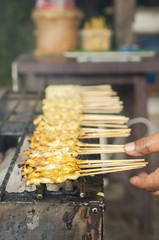 Pork satay on grilled stove.