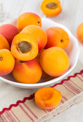 apricots in a bowl on wooden table