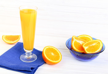 Glass of orange juice  on a light wooden background
