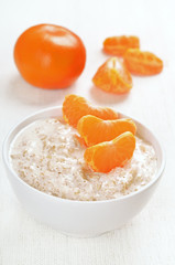 Oatmeal porridge with slices of tangerines
