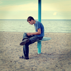 Teenager reading on the Beach