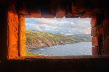 coast view inside of window frame of fortress