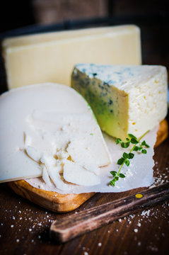 Assorted cheese on wooden background