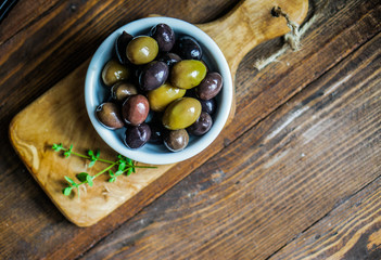 Olives on rustic wooden background