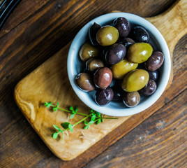 Olives on rustic wooden background