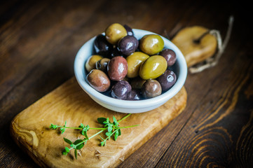 Olives on rustic wooden background