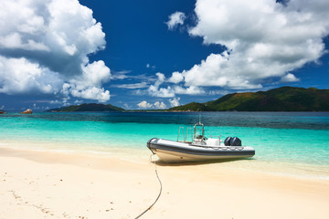 Fototapeta na wymiar Tropical beach at Seychelles with inflatable boat