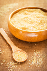 Brown sugar on wooden spoon and bowl