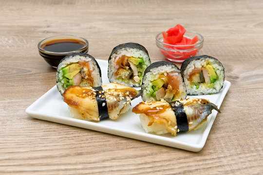Japanese sushi and rolls on a white plate