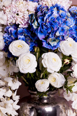 close-up of a bouquet of roses and hydrangea in a vase