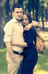 man and woman walking in the park