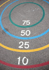 Fototapeta premium Quoits game with winning circles on asphalt