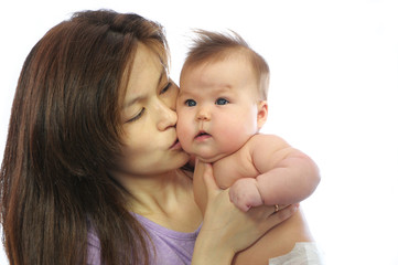 Mother kissing newborn baby