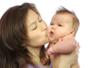 Mother kissing newborn baby