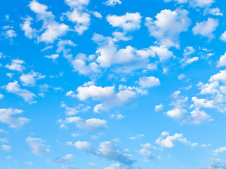 Fototapeta na wymiar lot of small white clouds in blue sky