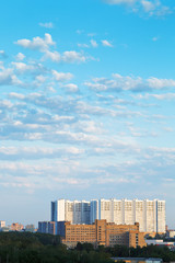 Fototapeta na wymiar large apartment building under blue summer sky