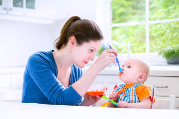 Baby boy eating his first solid food
