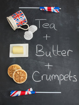 tea butter and crumpets on a blackboard with british flags