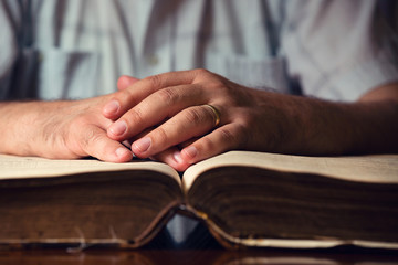 Male Hand On Open Bible