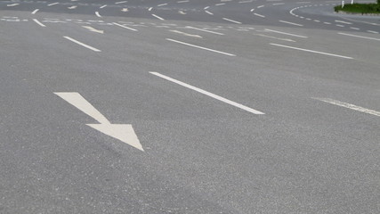 four-lane road and a white arrow