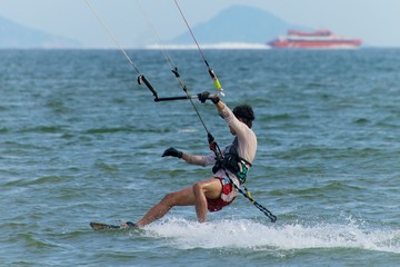 Male kite surfer with ferry on horizon