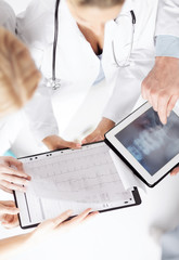 Fototapeta premium group of doctors looking at x-ray on tablet pc