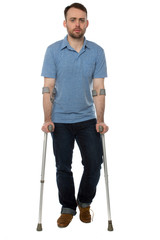 Young disabled man walking with forearm crutches
