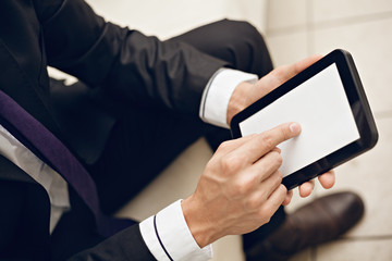 Young businessman using digital tablet