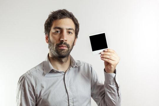 young man with empty photo frame - Powered by Adobe